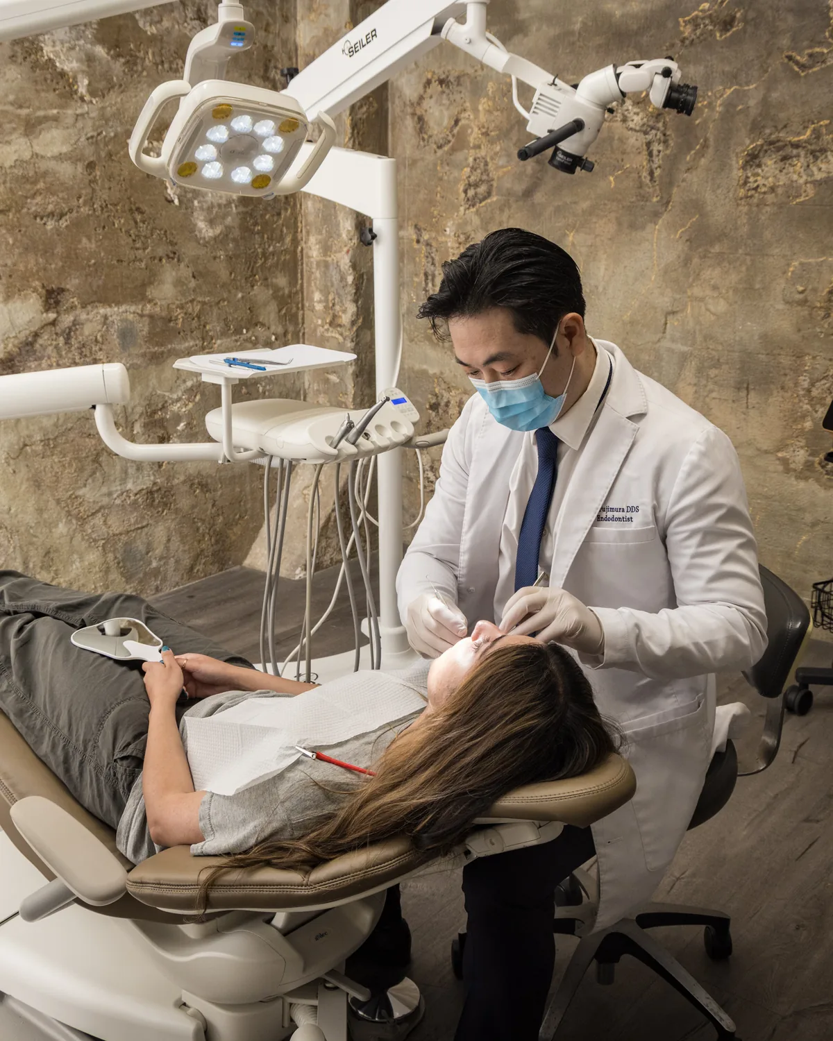 Dr. Atsushi Fujimura examining a patient in a treatment room at Endospecialists